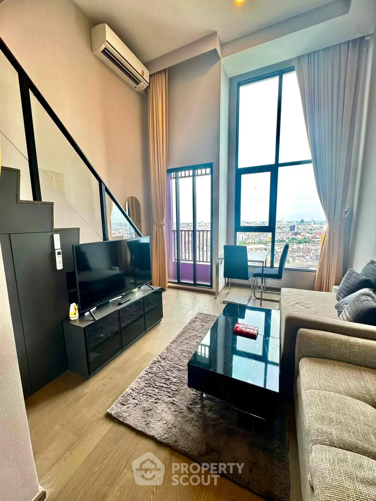 Modern loft-style living room with high ceilings and city view