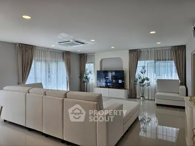 Spacious modern living room with elegant decor and large windows