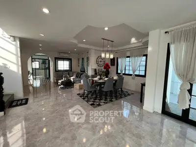 Spacious modern living and dining area with elegant decor and ample natural light.