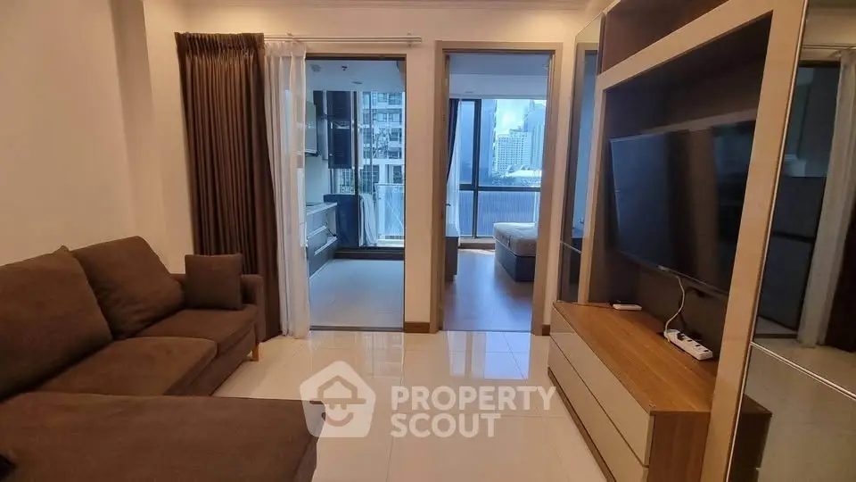 Modern living room with sleek furniture and city view balcony