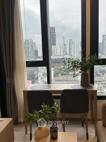 Modern apartment with city view, featuring stylish interior and large windows for natural light.