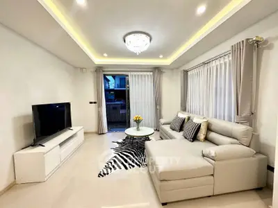 Modern living room with elegant lighting and stylish furniture, perfect for relaxation and entertainment.