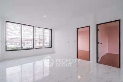 Spacious modern living room with large windows and marble flooring