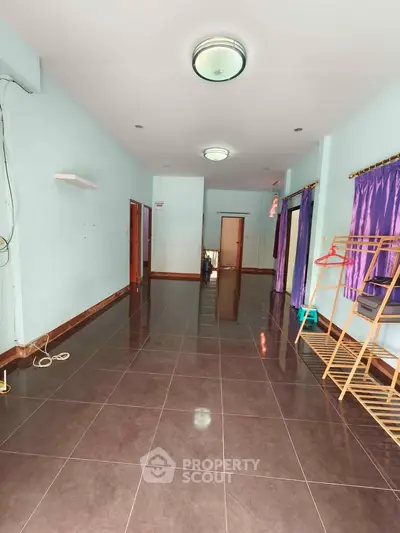 Spacious interior with tiled flooring and natural light, ideal for versatile living arrangements.