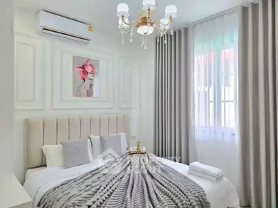 Luxurious bedroom with elegant decor and plush bedding in a modern apartment.