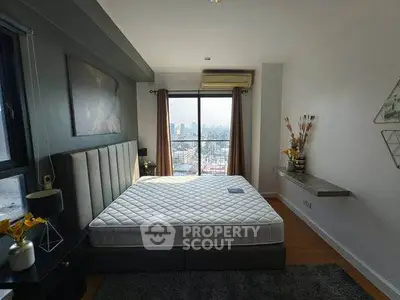 Spacious bedroom with city view and modern decor