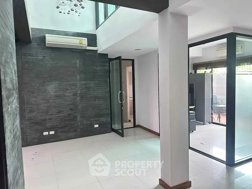 Modern interior space with glass doors and air conditioning, ideal for office or living area.