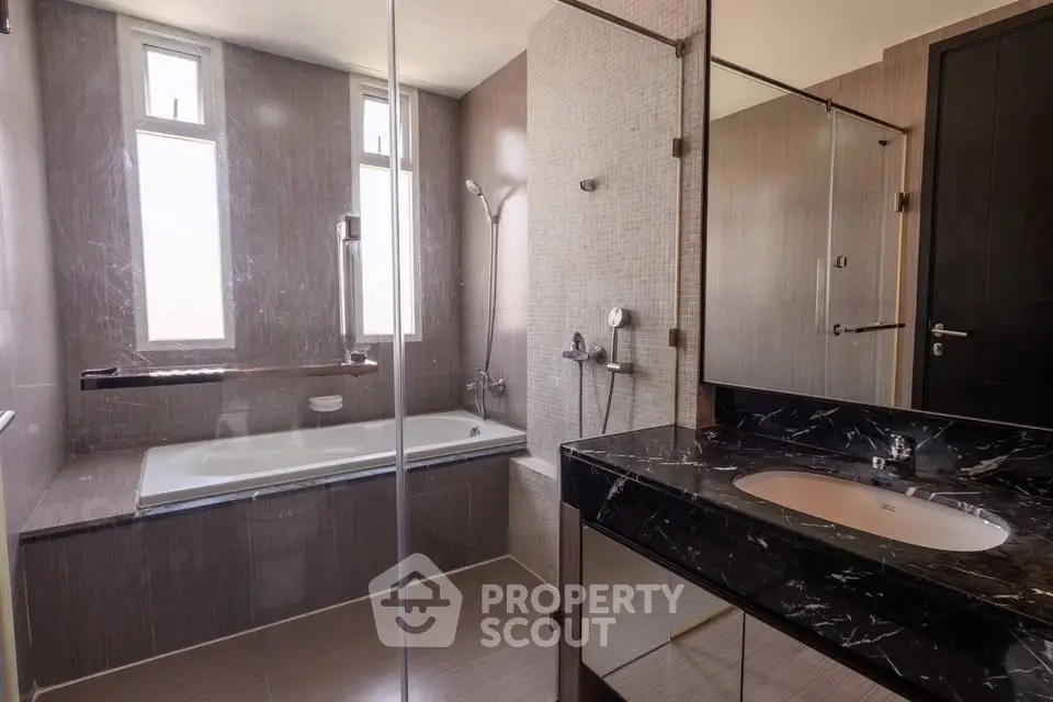 Luxurious modern bathroom with elegant marble sink and spacious bathtub