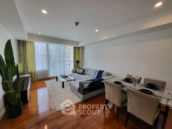 Spacious modern living room with elegant dining area and large windows.