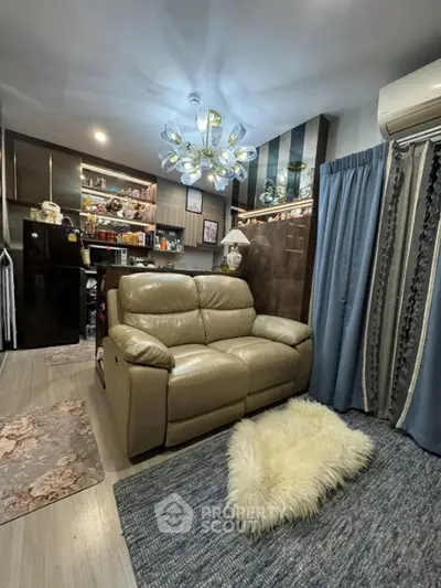 Cozy living room with modern chandelier and plush leather sofa