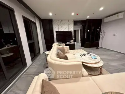 Luxurious modern living room with elegant beige sectional sofa and marble accents