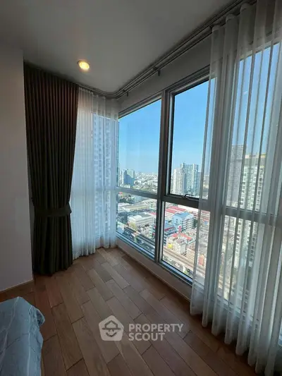 Bright corner unit bedroom with floor-to-ceiling windows and stunning city view.