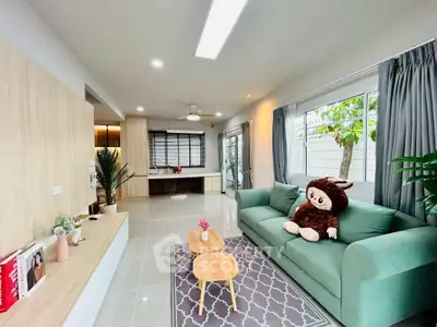 Spacious living room with modern decor and large windows for natural light