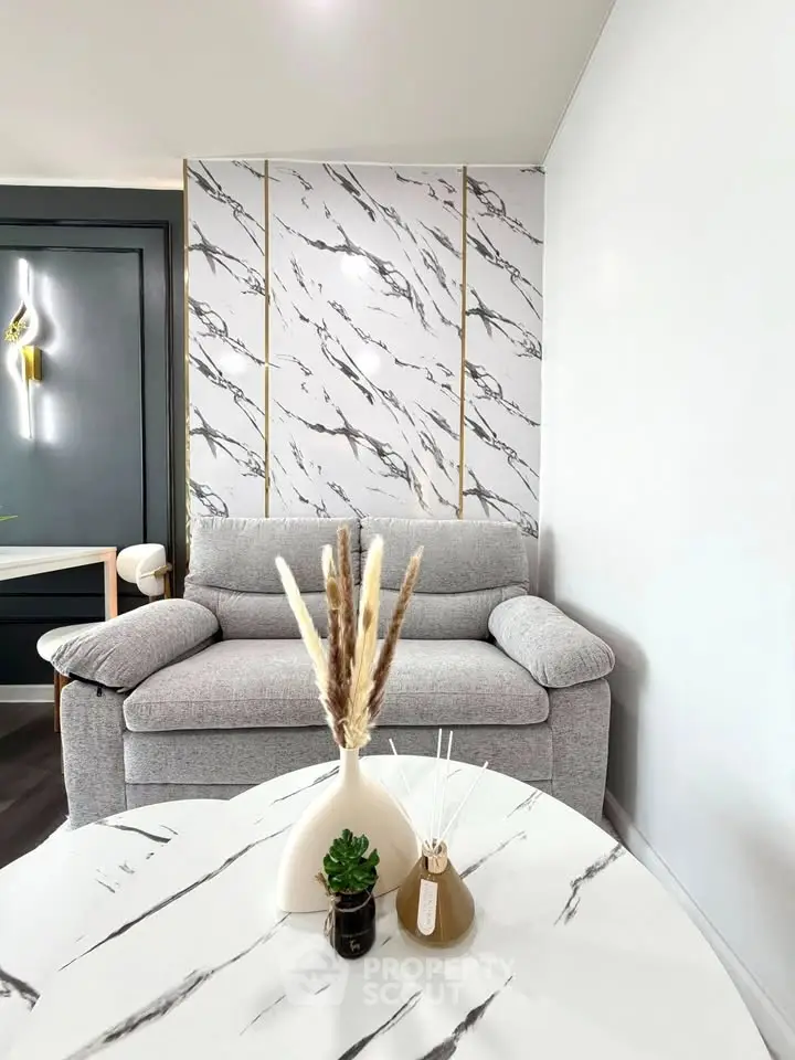 Stylish living room with modern marble accents and cozy gray sofa