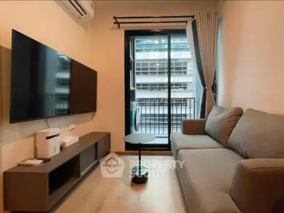 Modern living room with sleek furniture and large TV, perfect for urban living.