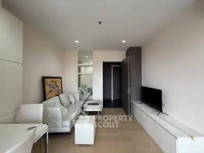 Modern living room with sleek furniture and wall-mounted TV in a stylish apartment.