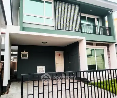 Modern two-story house with stylish facade and balcony