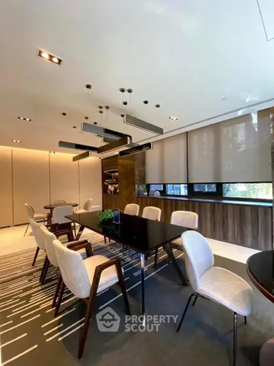 Elegant modern dining area with stylish lighting and large windows