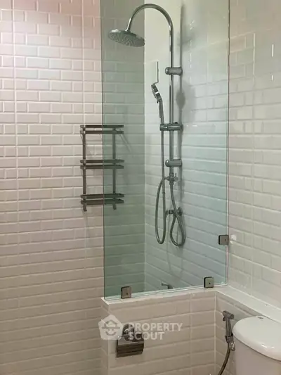 Modern bathroom with sleek shower and white subway tiles