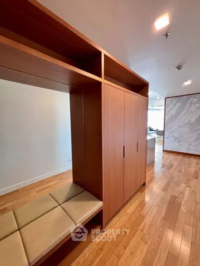 Spacious modern living area with wooden flooring and built-in storage, perfect for stylish urban living.