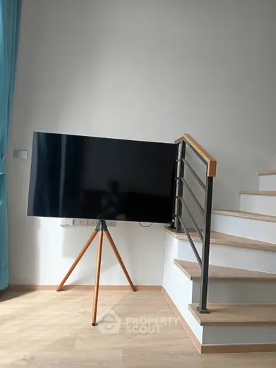 Modern interior with stylish TV stand and staircase in a contemporary home
