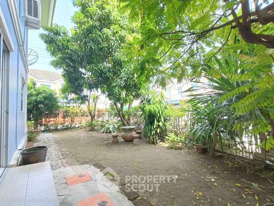 Charming garden area with lush greenery and serene atmosphere, perfect for relaxation and outdoor activities.