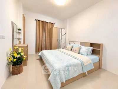 Spacious bedroom with elegant decor and natural light