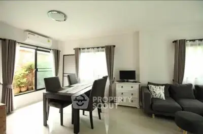 Modern living room with dining area and natural light