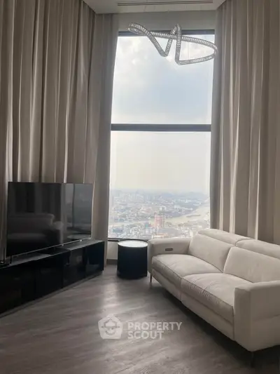 Luxurious high-rise living room with floor-to-ceiling windows and stunning city view.