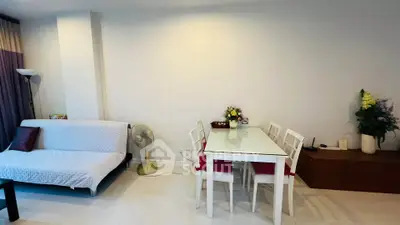 Charming living room with modern dining area and cozy sofa, perfect for relaxation and entertaining.