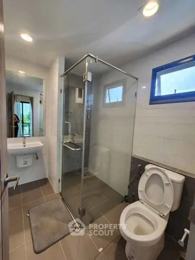 Modern bathroom with glass shower and sleek fixtures