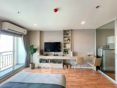 Modern bedroom with balcony, stylish decor, and natural light in urban apartment.