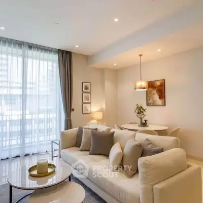 Elegant living room with modern decor and large windows in a luxury apartment.