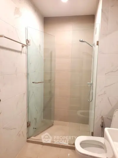 Modern bathroom with glass shower and elegant tile design