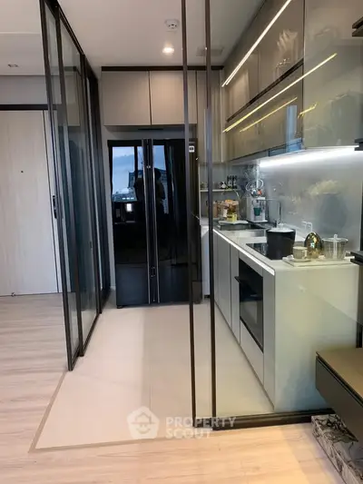 Modern kitchen with sleek cabinetry and built-in appliances in a contemporary apartment.