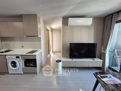Modern living room with sleek kitchen and balcony access