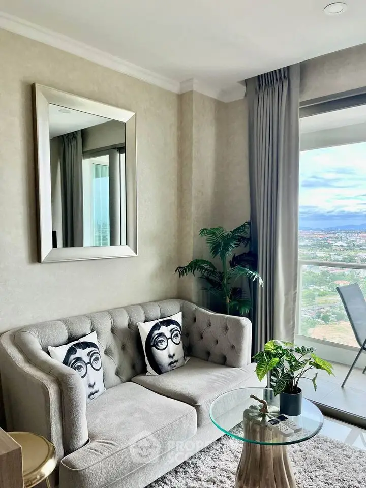 Stylish living room with plush sofa, artistic pillows, and panoramic window view