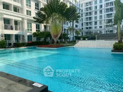 Luxurious residential pool area with modern architecture and lush greenery.