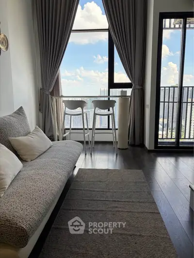 Modern living room with stunning city view and cozy seating area.