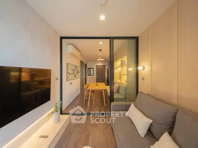 Modern living room with stylish decor and open layout, featuring a cozy sofa and wall-mounted TV.