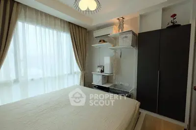 Cozy bedroom with large window and modern decor in a stylish apartment.