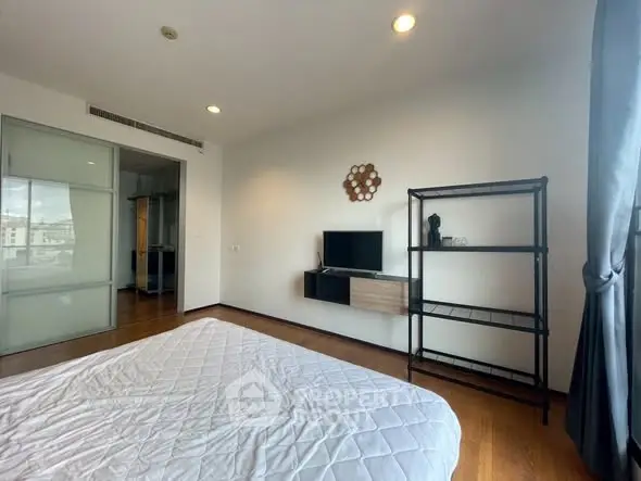 Spacious bedroom with modern decor and natural light