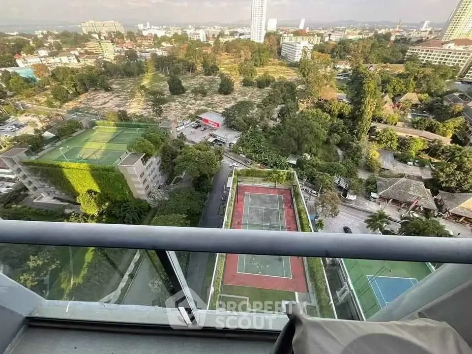 Stunning high-rise balcony view overlooking cityscape and sports courts