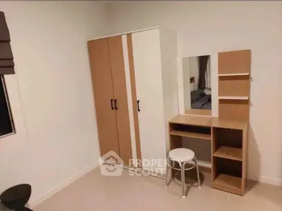Modern bedroom with stylish wardrobe and vanity set, perfect for urban living.