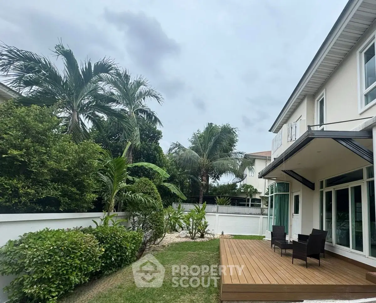 Luxurious home with spacious garden and elegant patio in tropical setting.