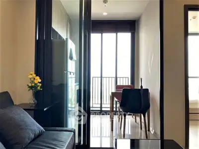 Modern apartment interior with sleek furniture and large windows offering natural light.