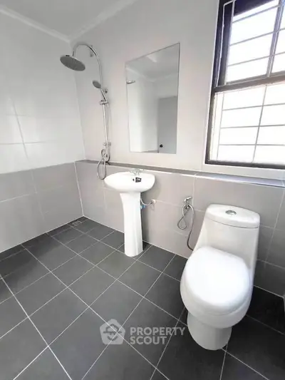 Modern bathroom with sleek fixtures and large window for natural light.