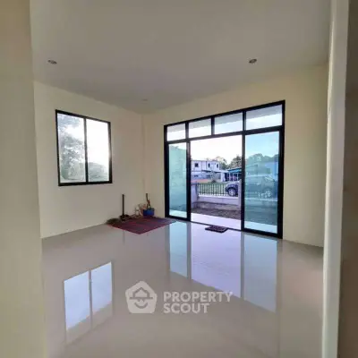 Spacious room with large windows and glossy floor, ideal for customization.