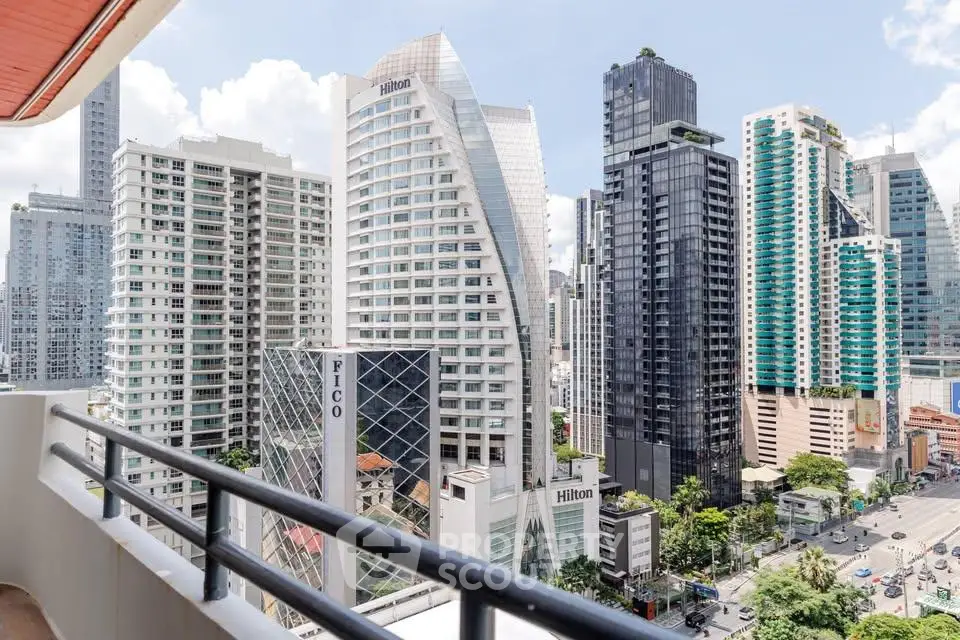 Stunning cityscape view from a high-rise balcony showcasing modern skyscrapers and vibrant urban life.