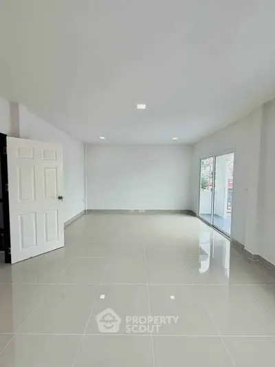 Spacious empty room with large windows and glossy tiled floor, perfect for customization.